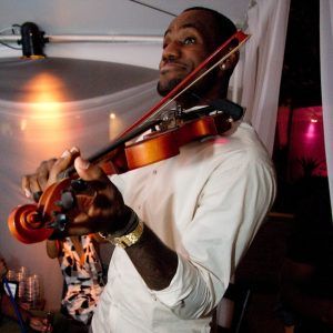LeBron and Chris playing violin and singing.
